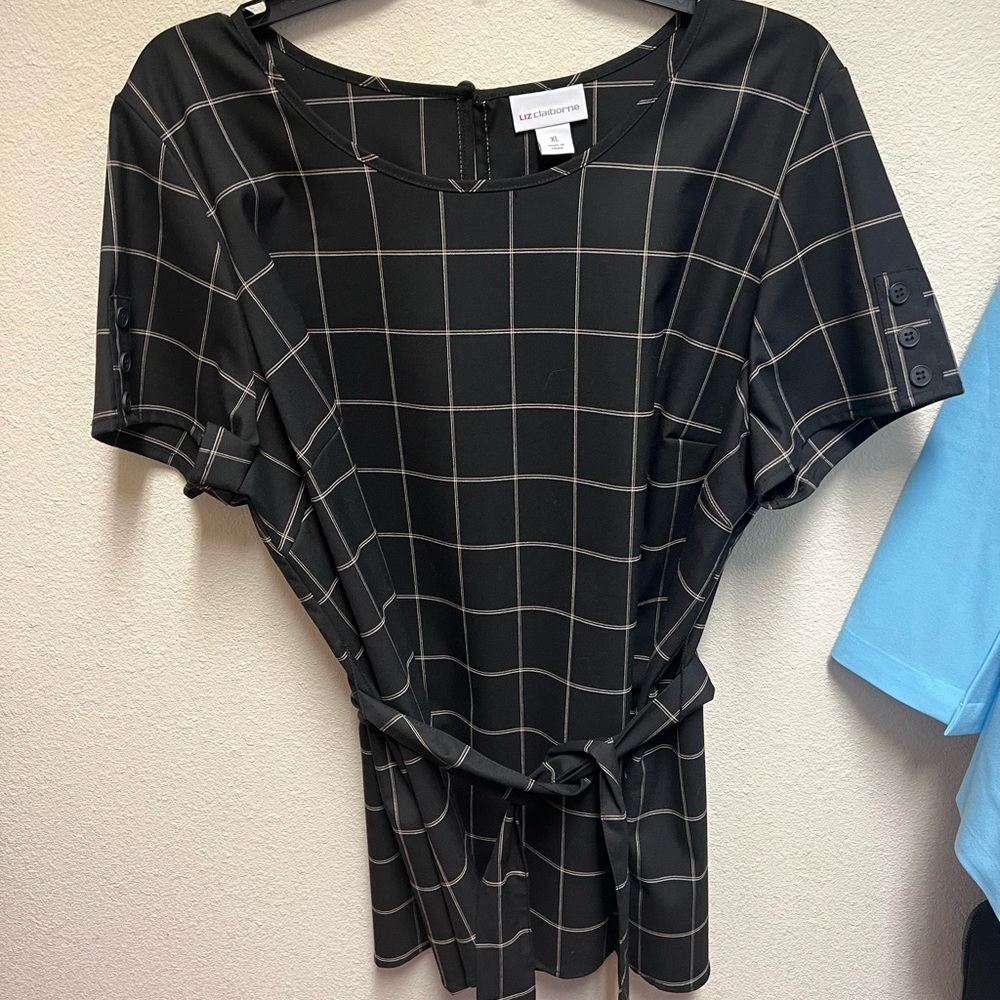 Women’s suit. Dress shirt and pants with a waist belt.